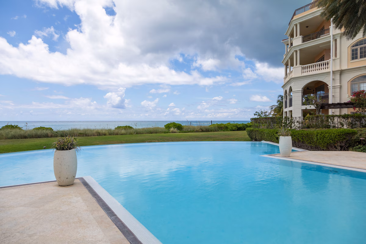 Poolside at The Somerset on Grace Bay, the turquoise water beyond